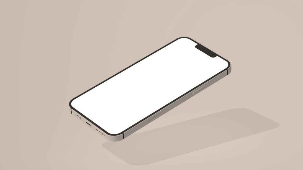 a white cell phone sitting on top of a table